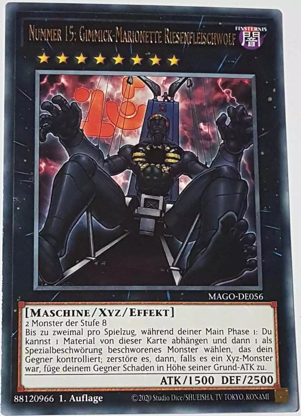 Nummer 15: Gimmick-Marionette Riesenfleischwolf MAGO-DE056 ist in Gold Rare Yu-Gi-Oh Karte aus Maximum Gold 1. Auflage
