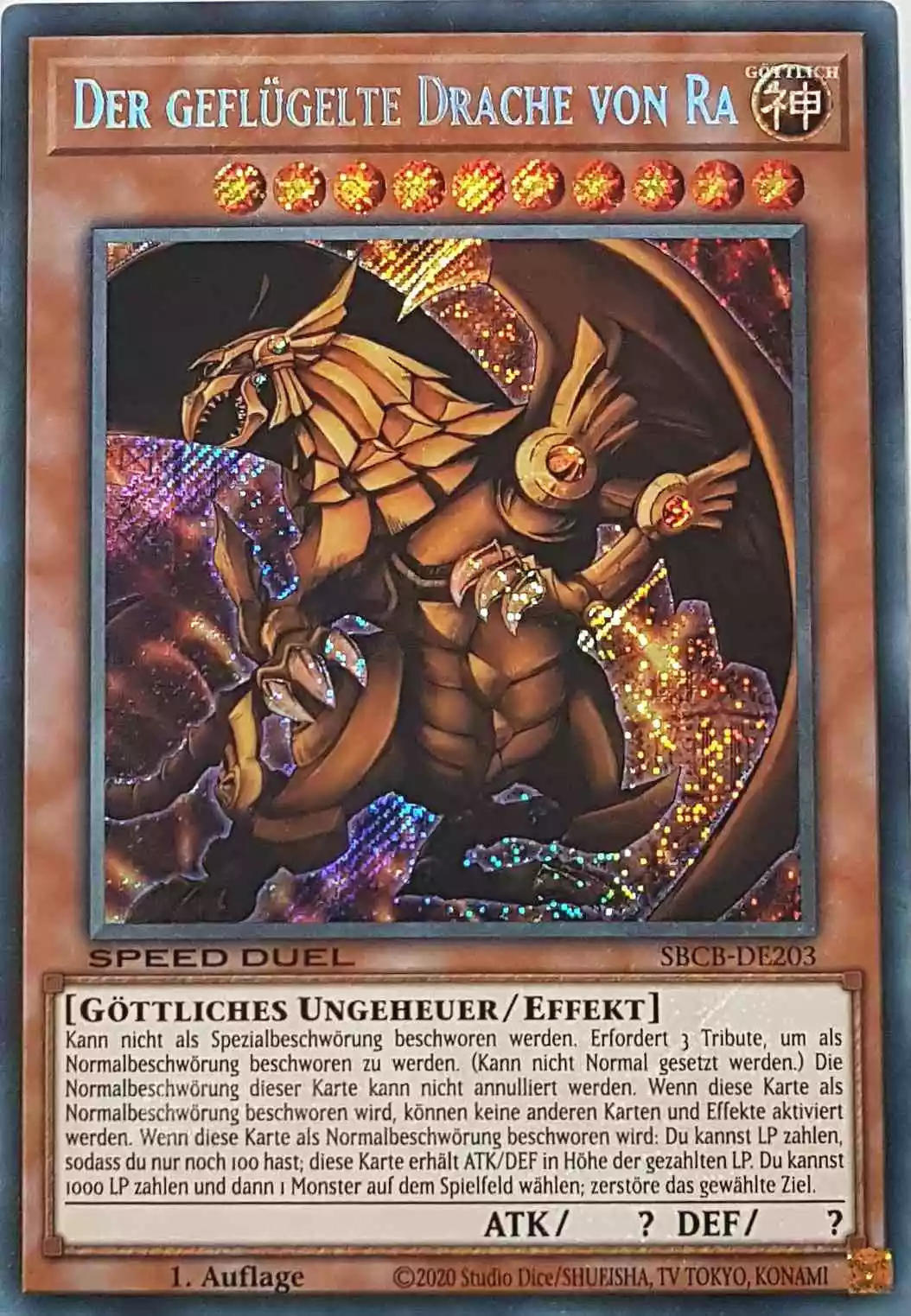 Der geflügelte Drache von Ra SBCB-DE203 ist in Secret Rare Yu-Gi-Oh Karte aus Speed Duel Battle City Box 1. Auflage